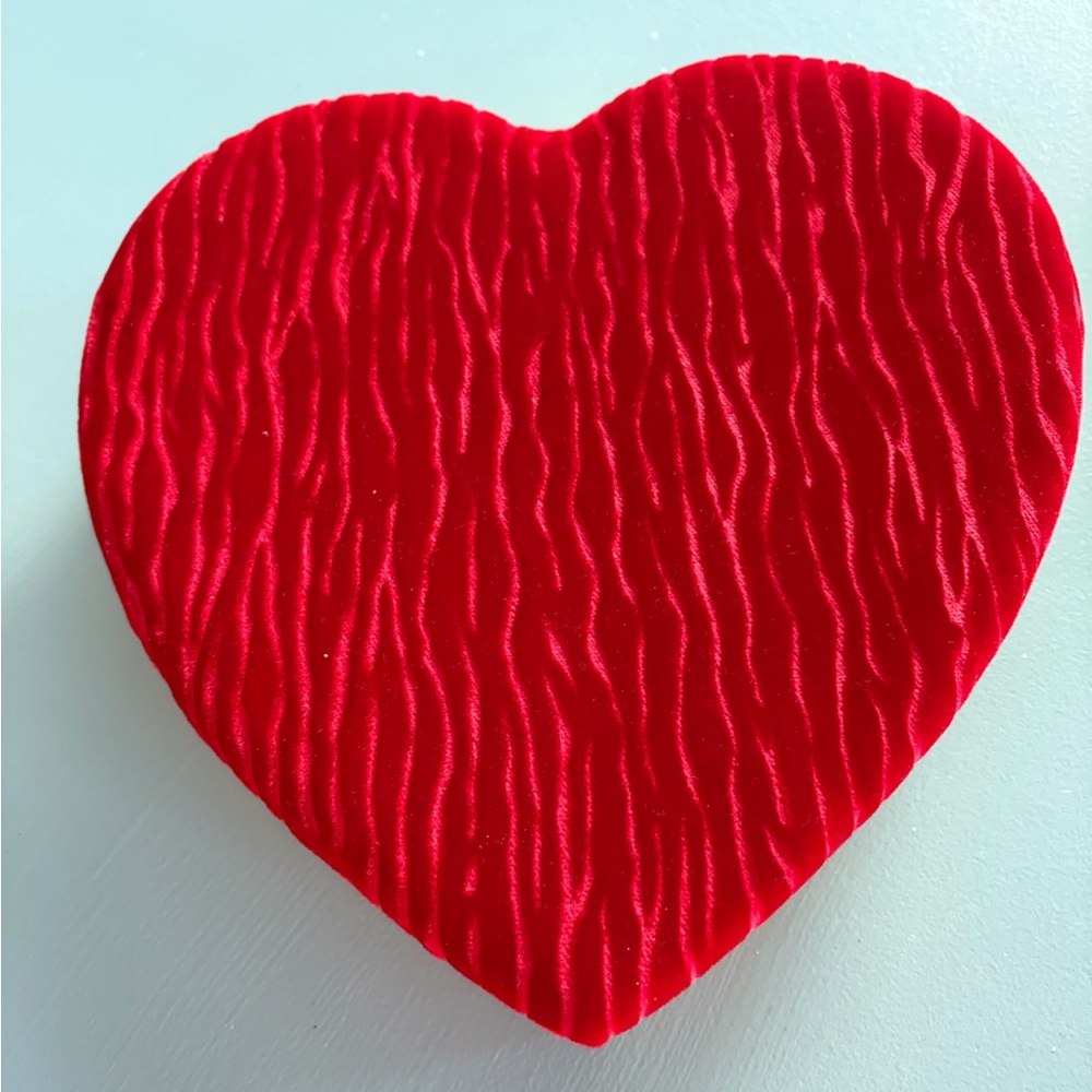 Red Heart-Shaped Velvet Box filled with earrings and brooches.